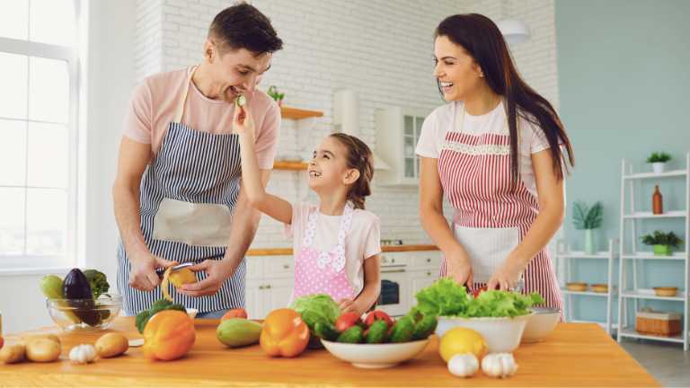 Mom and dad preparing her a meal together.