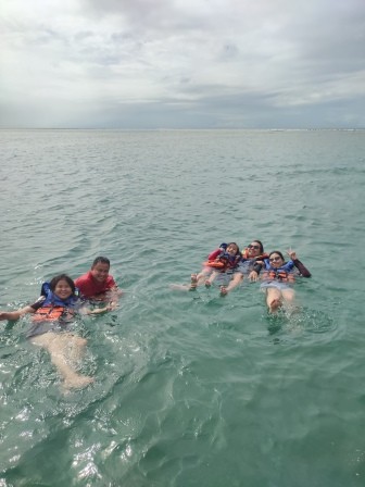 Group of people enjoying the cold water, relaxing and soaking in the refreshing atmosphere.