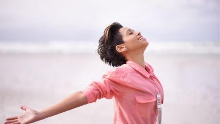 Woman releasing her hands, symbolizing freedom and the beginning of self-rebuilding.